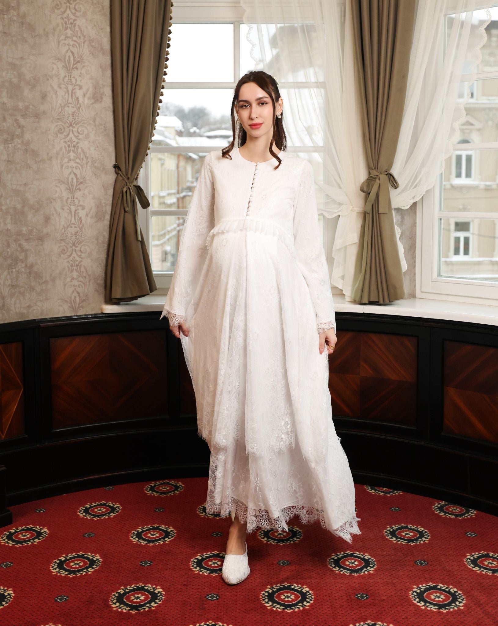 A dynamic view of the floor-length gown in motion, illustrating the weightless and fluid movement of the lace layers.