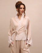 A close-up of the Pyjamas Set top, focusing on the wrap-over style and delicate lace detailing along the neckline.