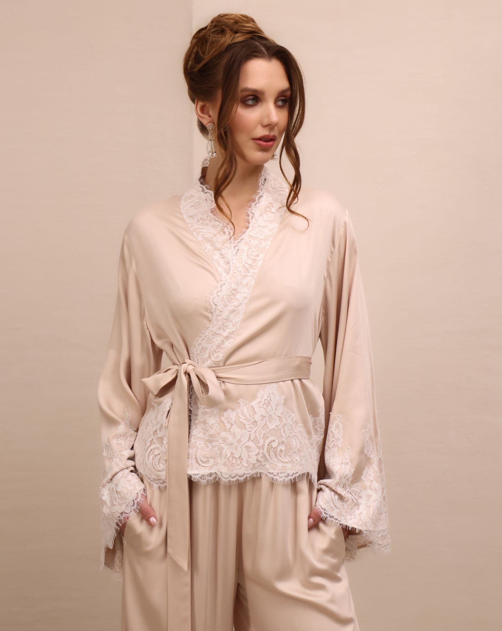 A close-up of the Pyjamas Set top, focusing on the wrap-over style and delicate lace detailing along the neckline.