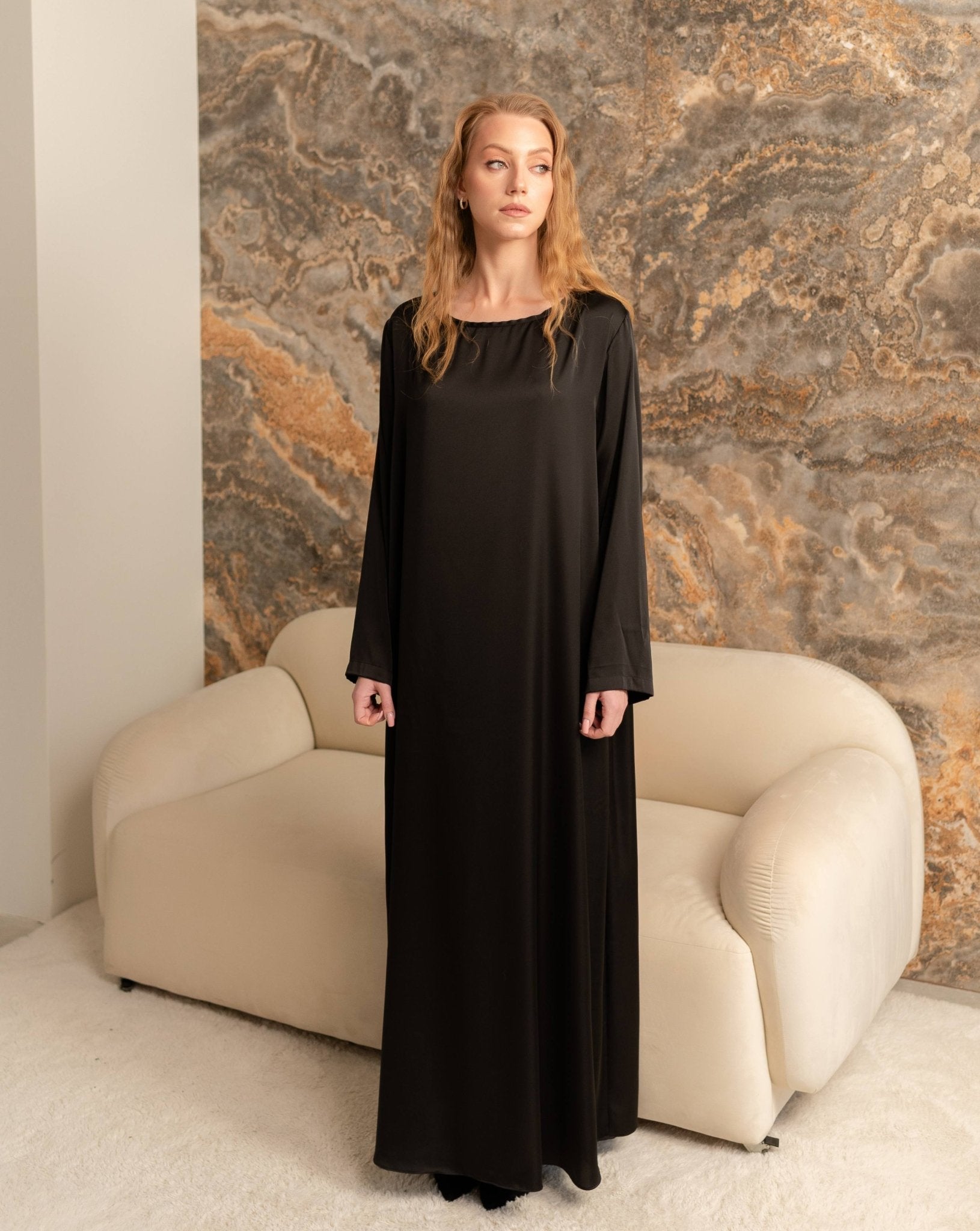 Straight frontal shot of the long satin dress, showcasing the simple yet refined look of the loungewear.