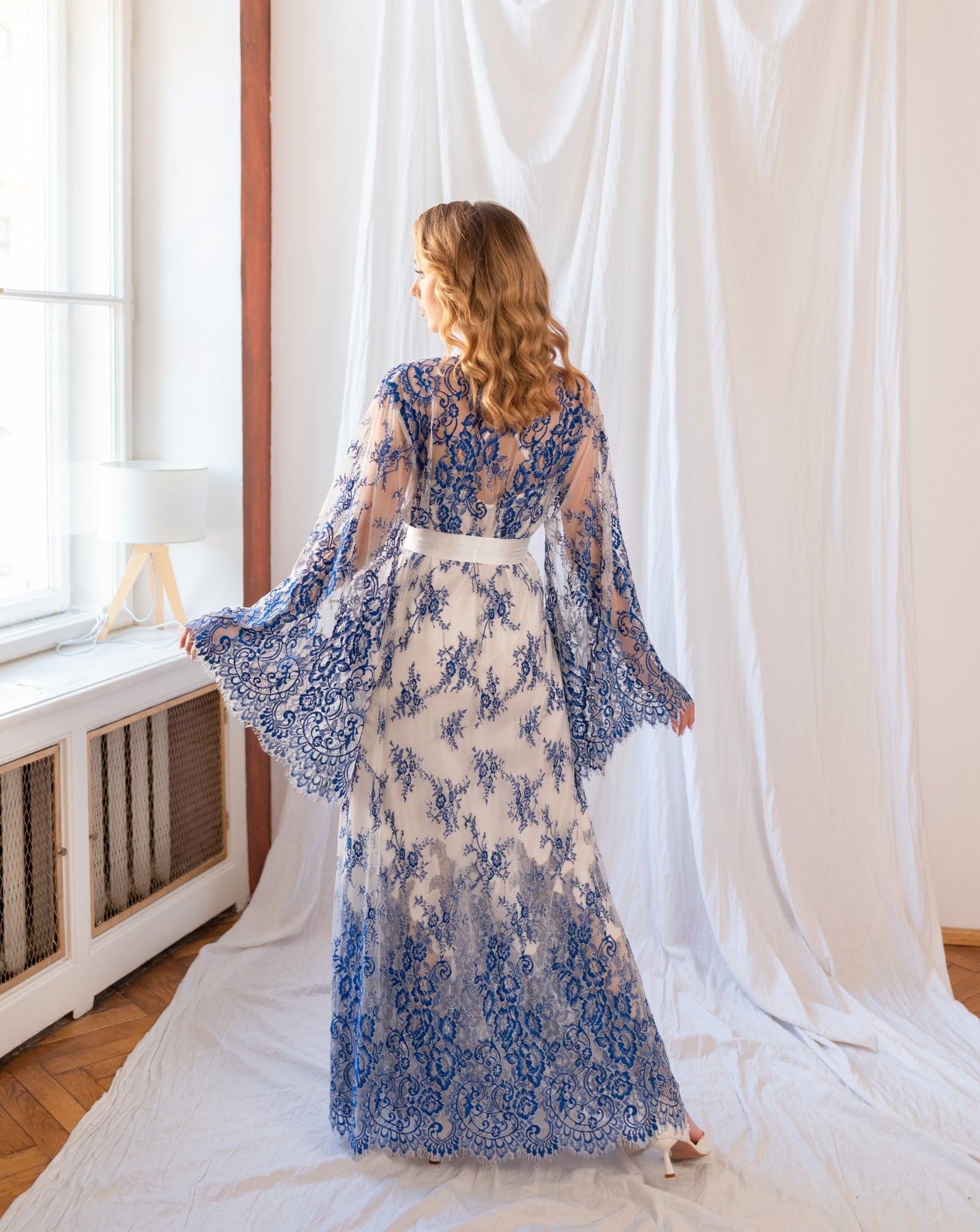Blue and white lace robe layered over full-length white gown - backview