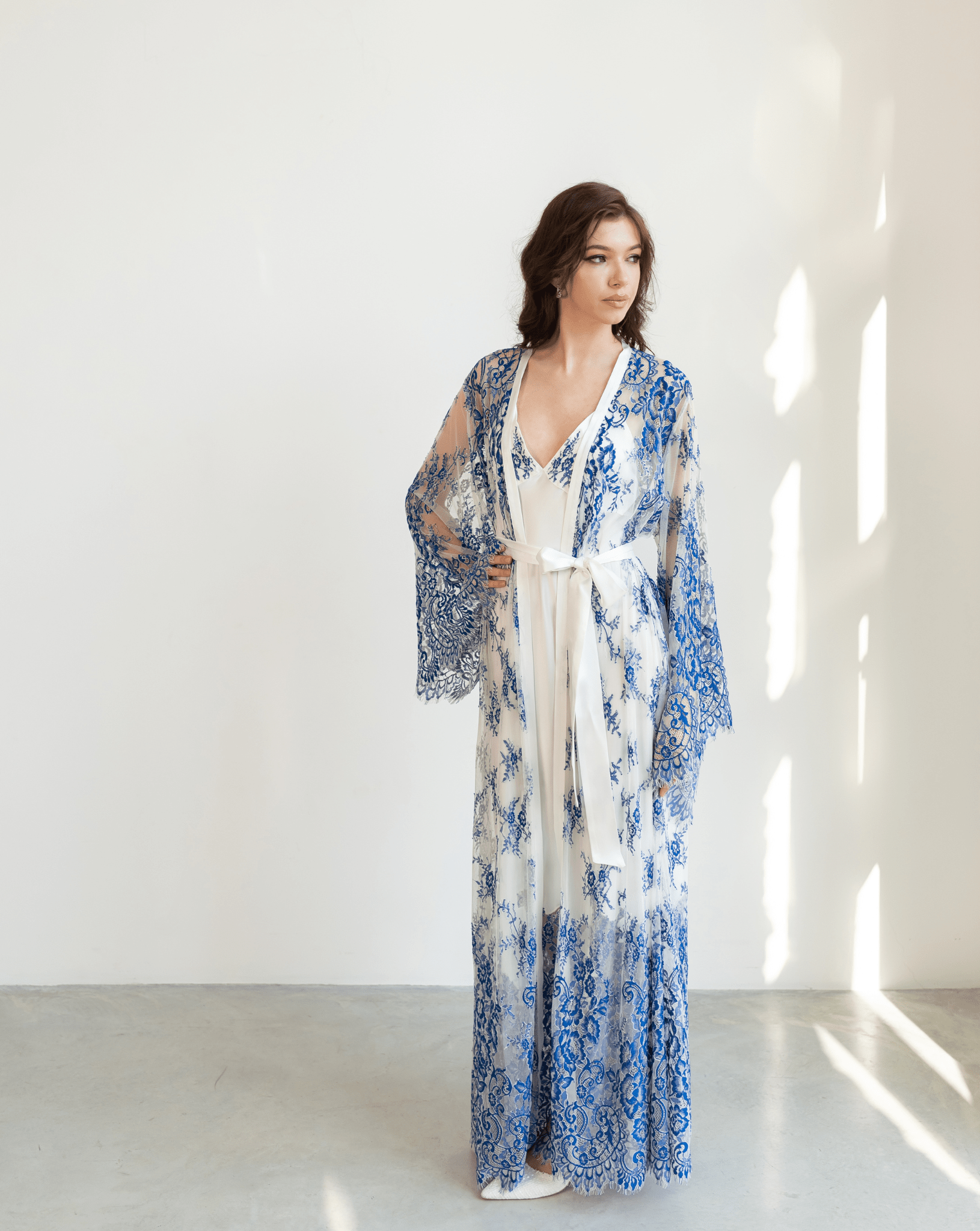 Blue and white lace robe layered over full-length white gown