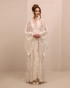 A poised frontal shot focusing on the wide sleeves of the lace robe, designed for elegance and presence.