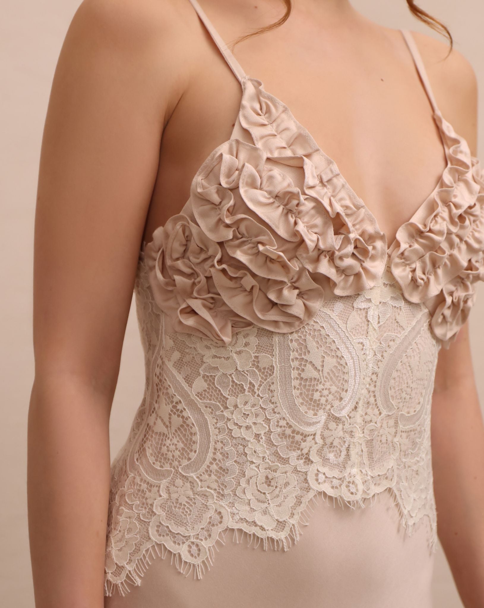 A close-up of the Robe and Nightgown Set's inner slip, focusing on the expressive ruffle detailing and lace.