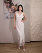 Front view of the cotton nightgown with a hand on the waist, showing the V-neckline and fine lace trim details.