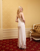 Side and back view of the white slip dress, highlighting the slim shoulder straps and graceful silhouette.