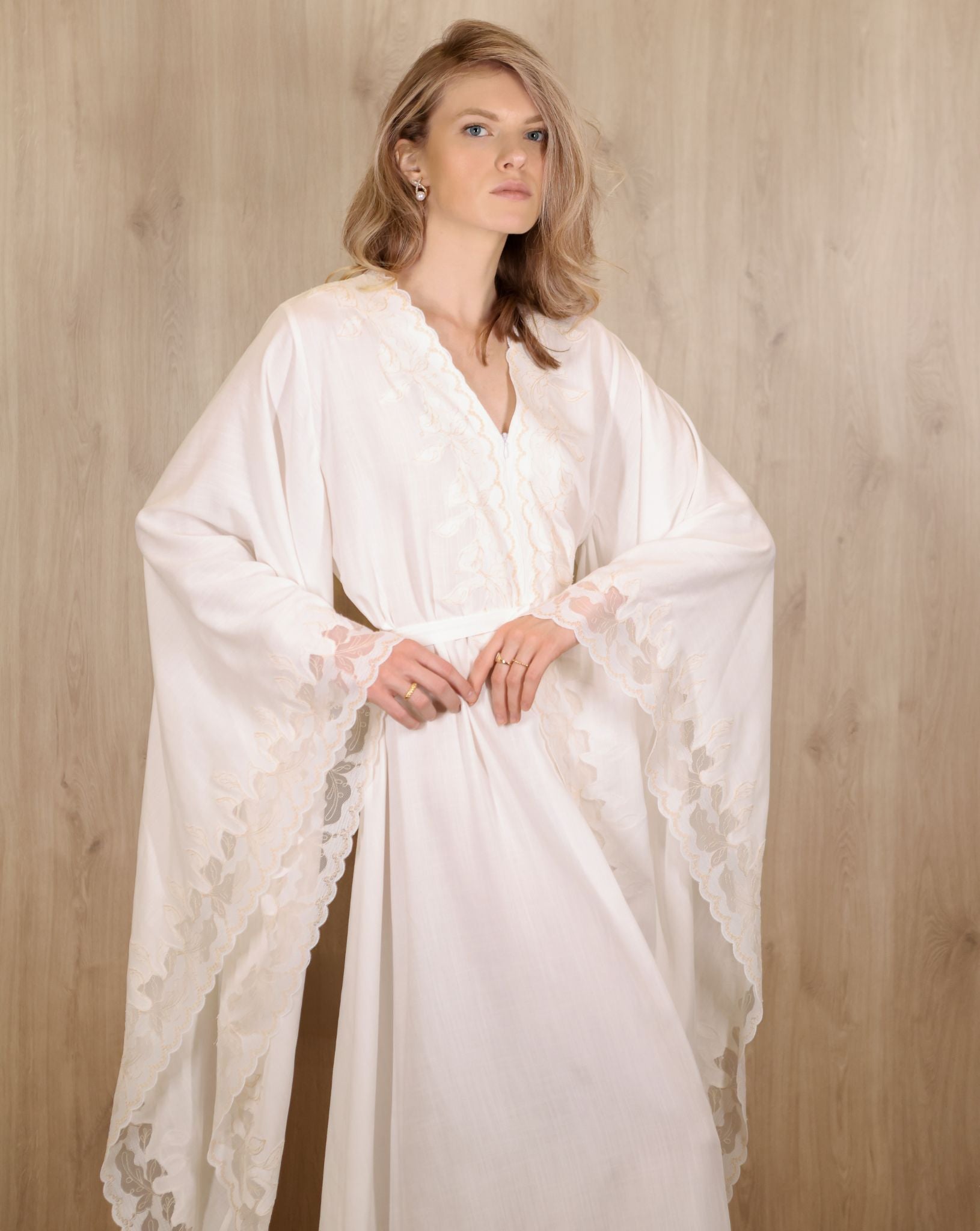 Side view of a flowing cream kaftan in motion