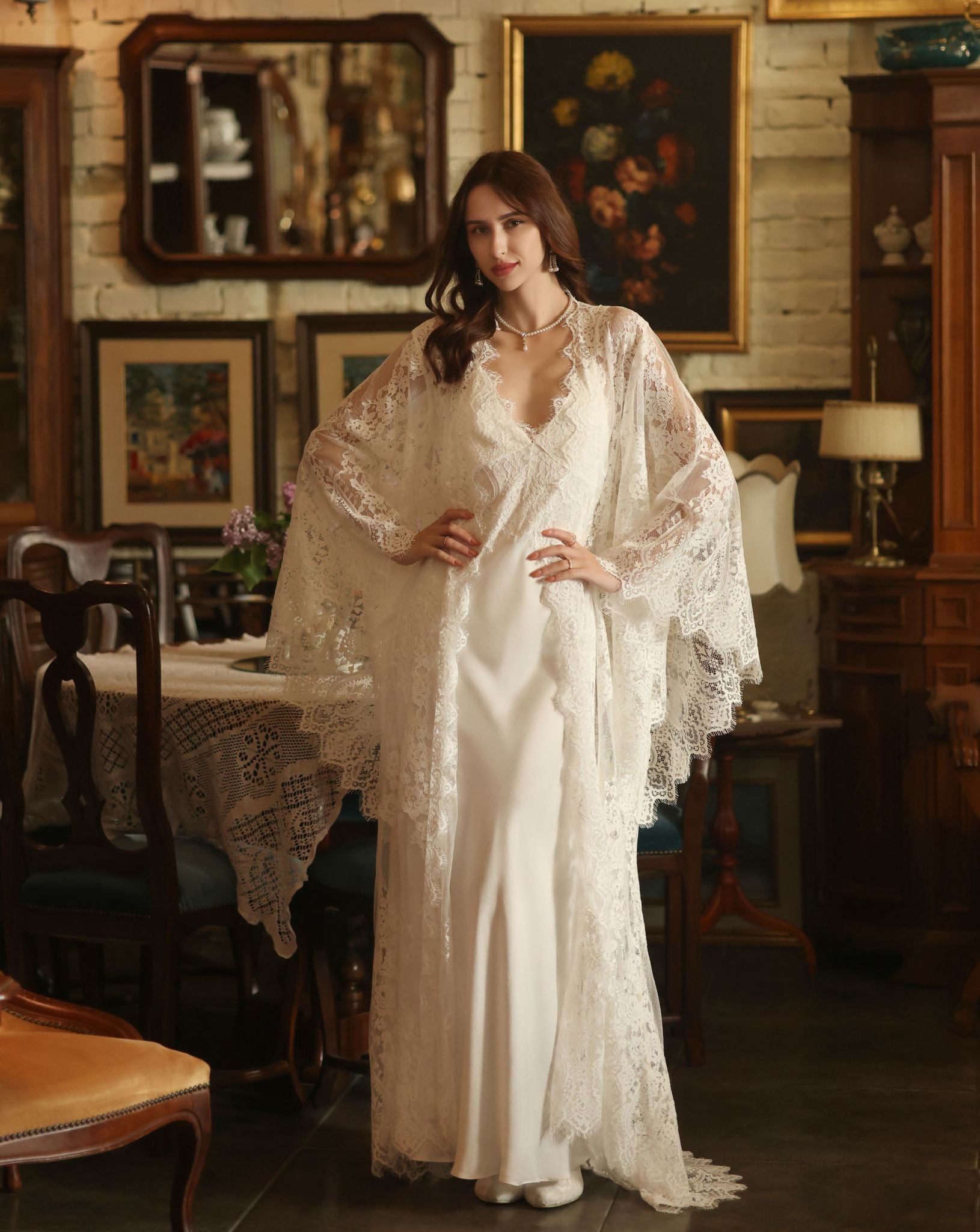 A posed view of the Bridal Robe and Nightgown Set with hands on the waist to showcase the airy lace sleeves.