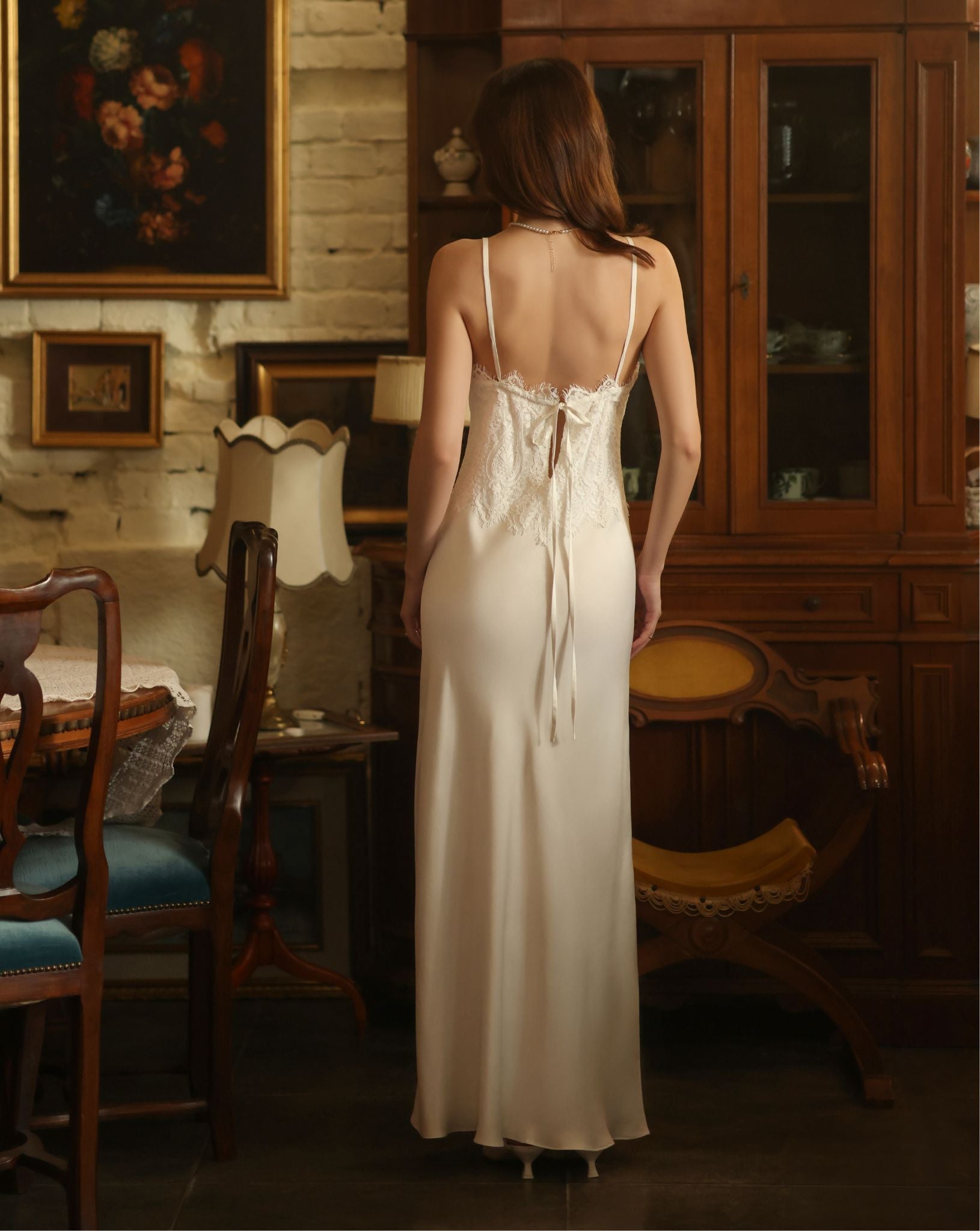 Rear view of the nightgown, showcasing the adjustable shoulder straps and delicate lace detailing across the back.