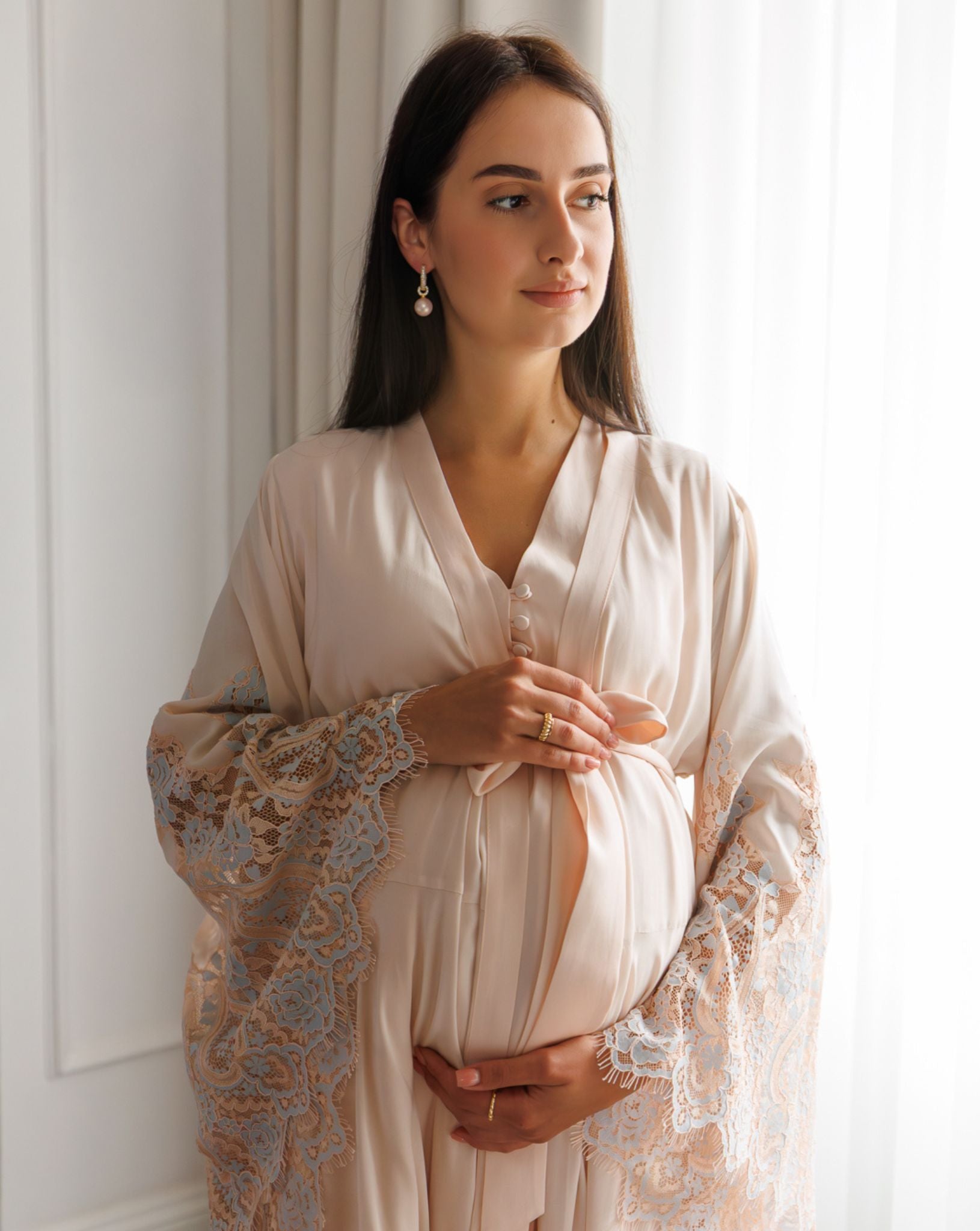 Close-up of maternity nightwear with sheer lace robe and bow tie belt by Kafemme