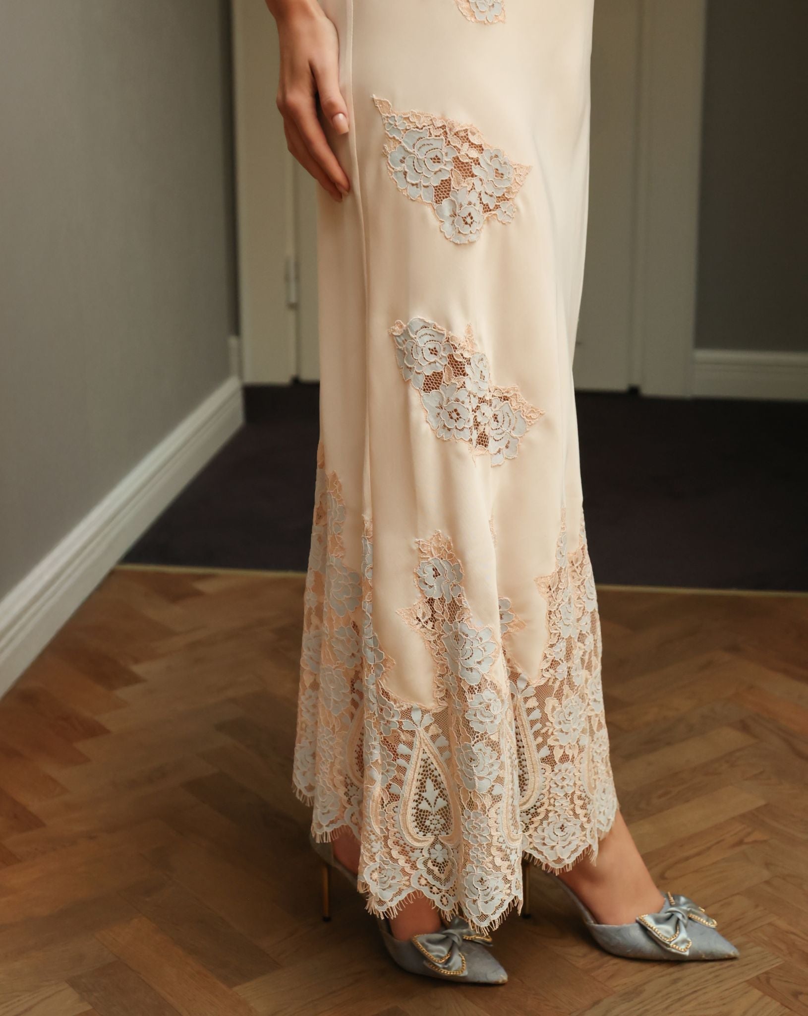 Close-up of the hem featuring scattered lace appliqués, adding a touch of sophisticated luxury to the set.