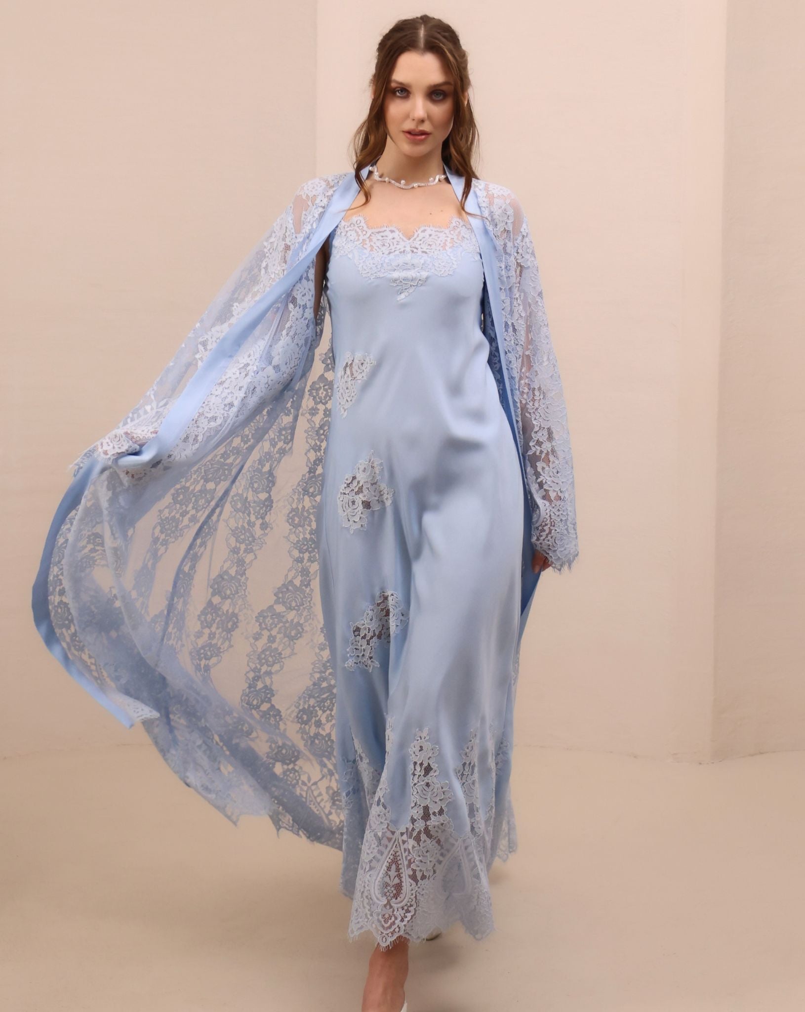 A spirited shot of the attire in motion, illustrating the artistic charm of the scattered lace appliqués.