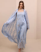 A spirited shot of the attire in motion, illustrating the artistic charm of the scattered lace appliqués.