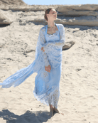 A dynamic shot of the Robe and Nightgown Set on the sand, capturing the artistic lace appliqués and flowing silhouette.