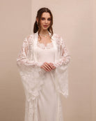 A mid-length shot focusing on the wide sleeves and the delicate lace along the neckline for a feminine look.