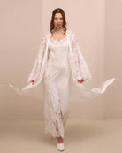 A dynamic motion shot of the lace robe flowing to both sides, capturing the airy movement of the floor-length cut.