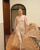 Dynamic shot of a flowing lace robe in motion, capturing the luxury and artistic charm of the ensemble.