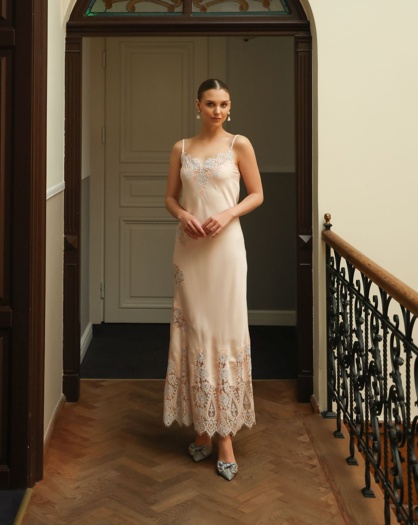 Front view of the cotton nightgown featuring delicate lace along the neckline and scattered artistic appliqués.