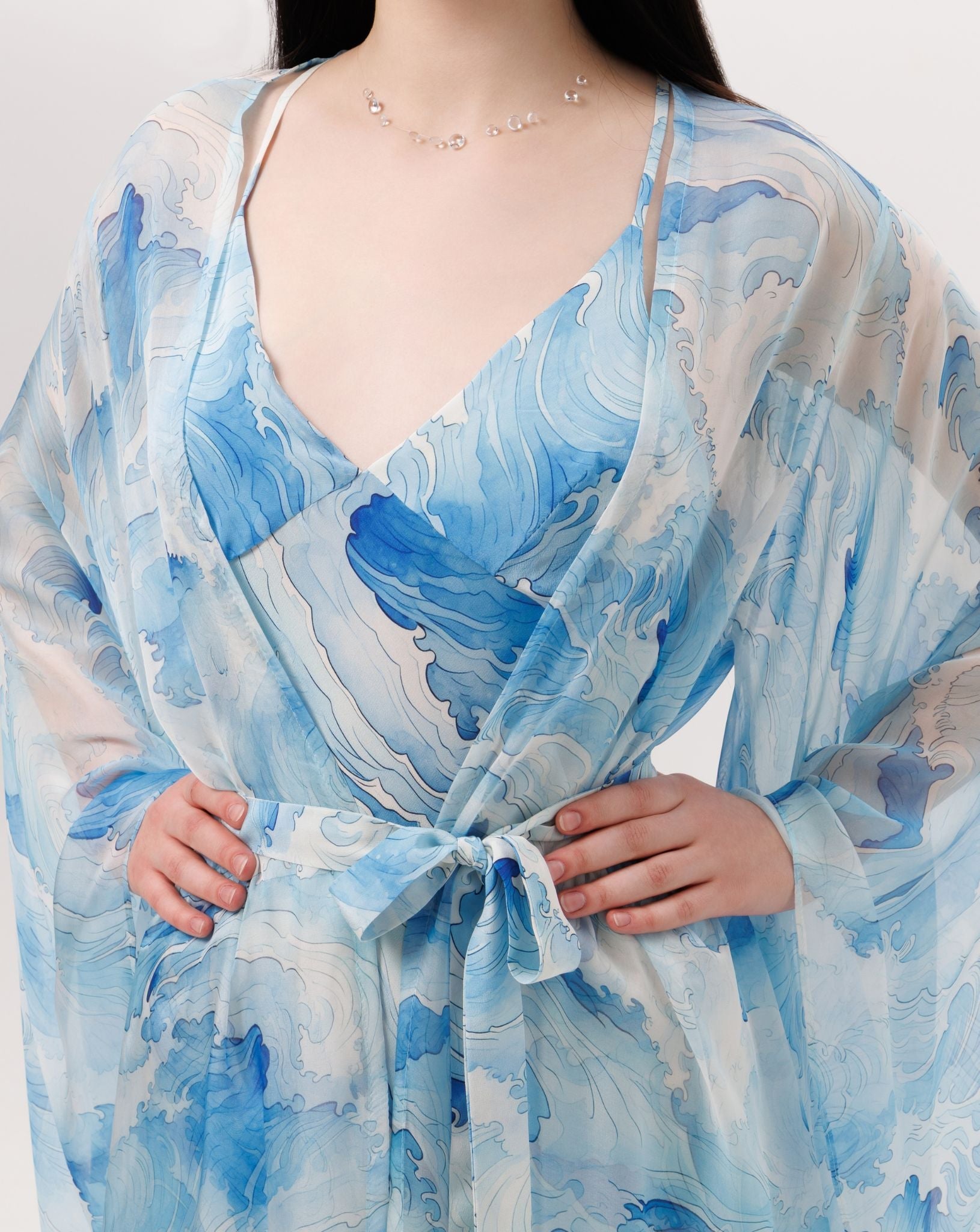 Close-up of the wrapped robe at the waist, highlighting the natural elegance and understated luxury of the silk crepe.