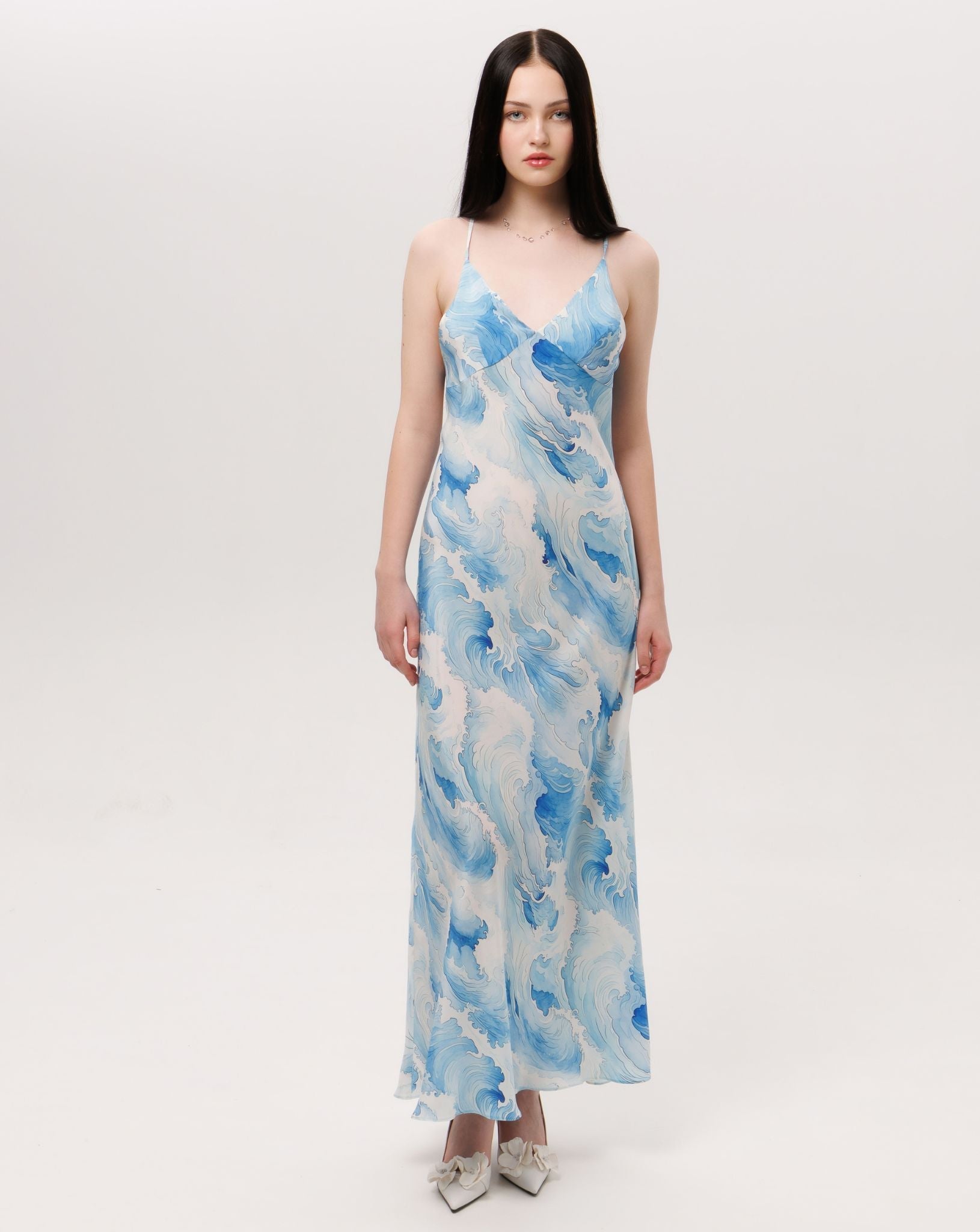 Front view of the silk slip dress featuring a delicate V-neckline and a smooth, flowing silhouette that feels effortless.