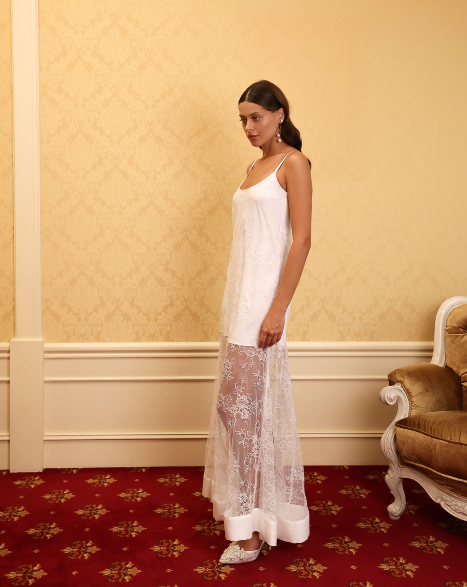 Side view of the long white nightdress, highlighting the effortless grace and the beautiful play of light on satin.