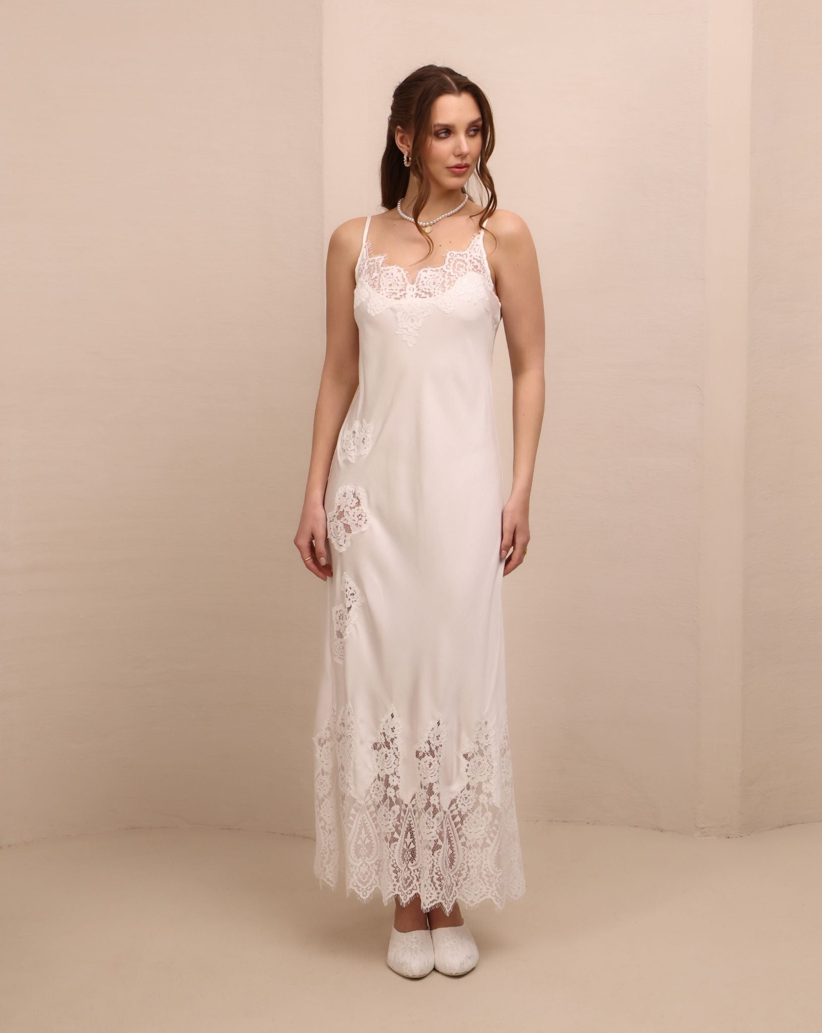 Frontal view of the nightgown featuring delicate lace detailing and adjustable shoulder straps for a perfect fit.