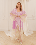 A posed view with hands placed slightly to the side of the belly, beautifully demonstrating the long sleeves.
