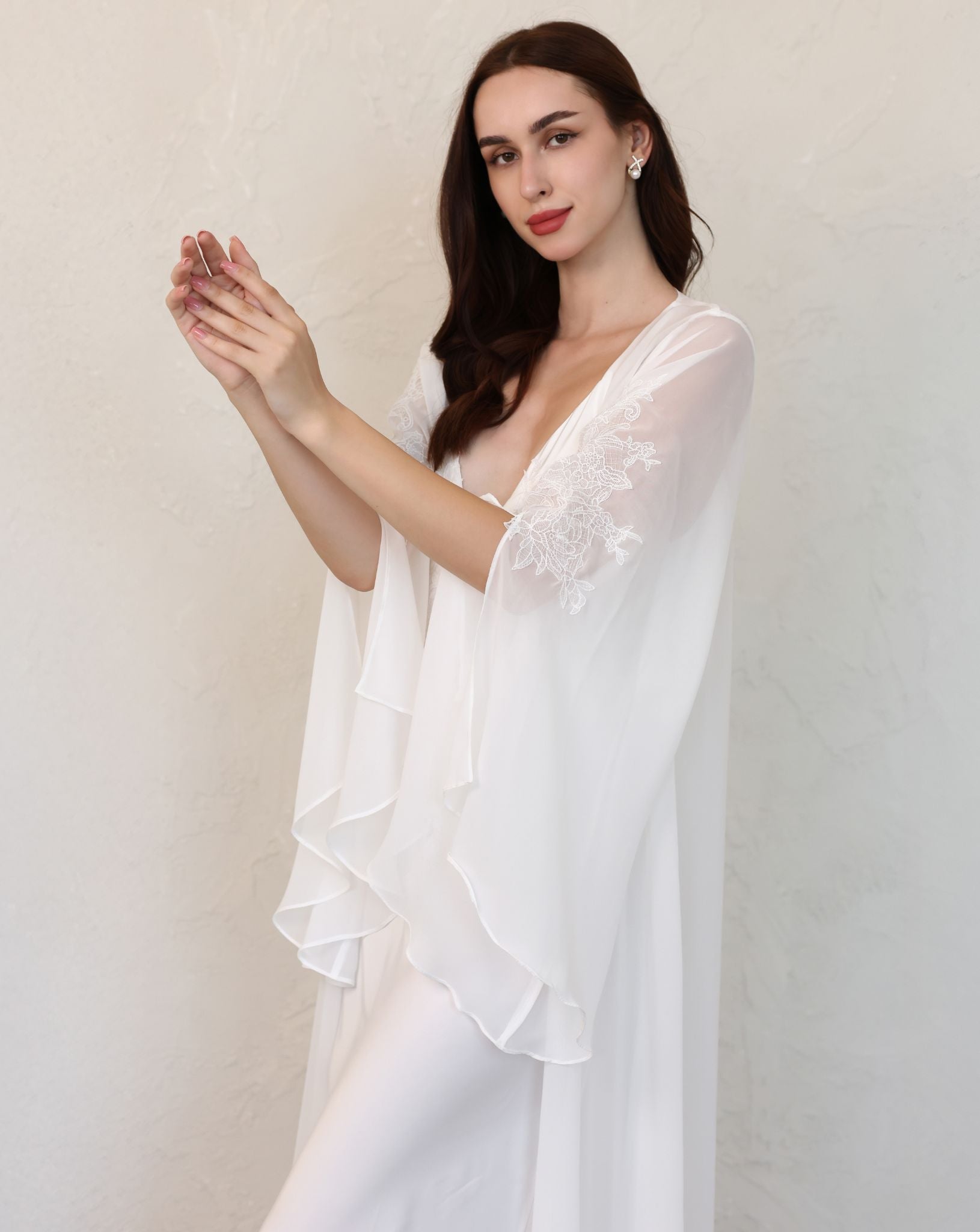 Mid-length shot of a sheer white robe, focusing on the sophisticated sleeve slits and delicate lace embroidery details.
