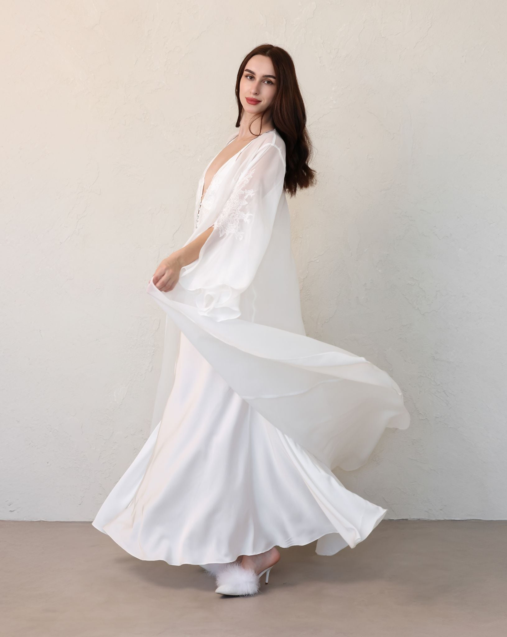Full-length view of the complete maternity ensemble in motion, with both the robe and nightgown flowing gracefully.