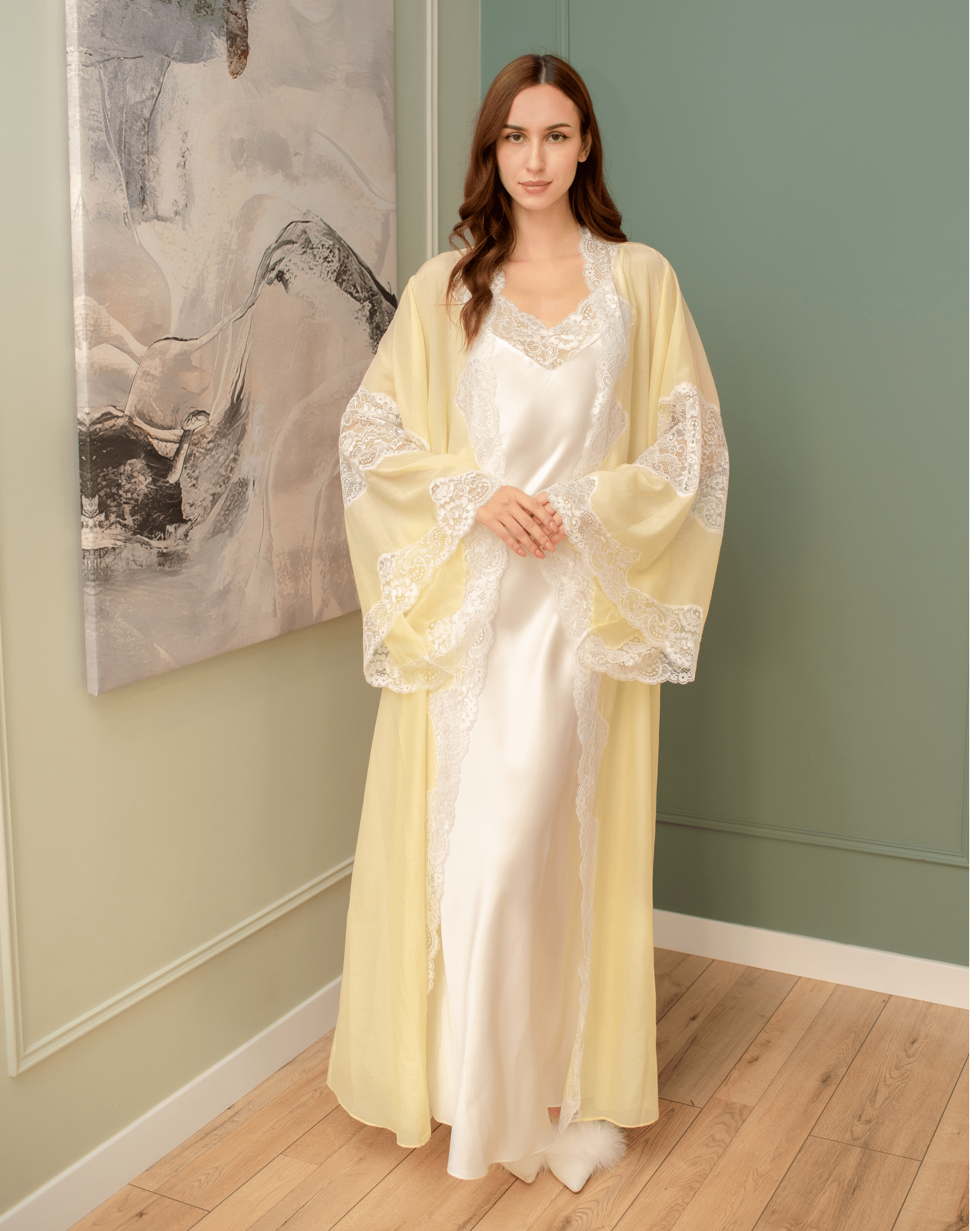 Full ensemble view with hands on the stomach, highlighting the timeless quality and weightless feel of the chiffon.