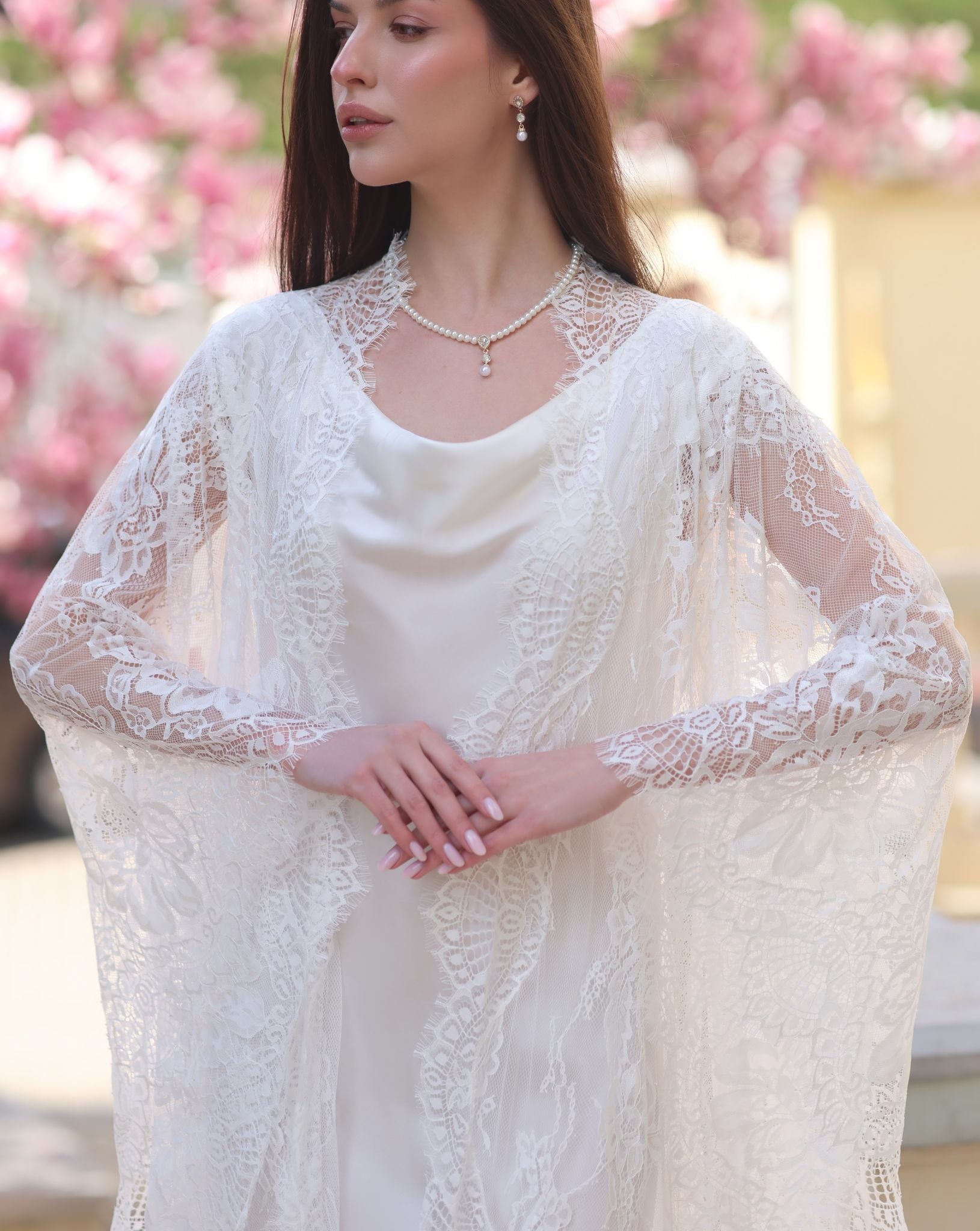 A detailed view from head to hips, focusing on the intricate lace of the robe and the soft texture of the silk.