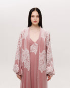 Mid-length shot of the ensemble focusing on the lace that traces the sleeves and chest like delicate frost.