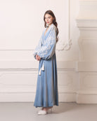 Full-length side profile, showcasing the fluid drape and visual poetry of the voluminous velvet layers.