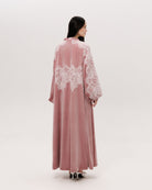 Back view of the floor-length velvet robe, showing the soft drama and poetic movement of the material.