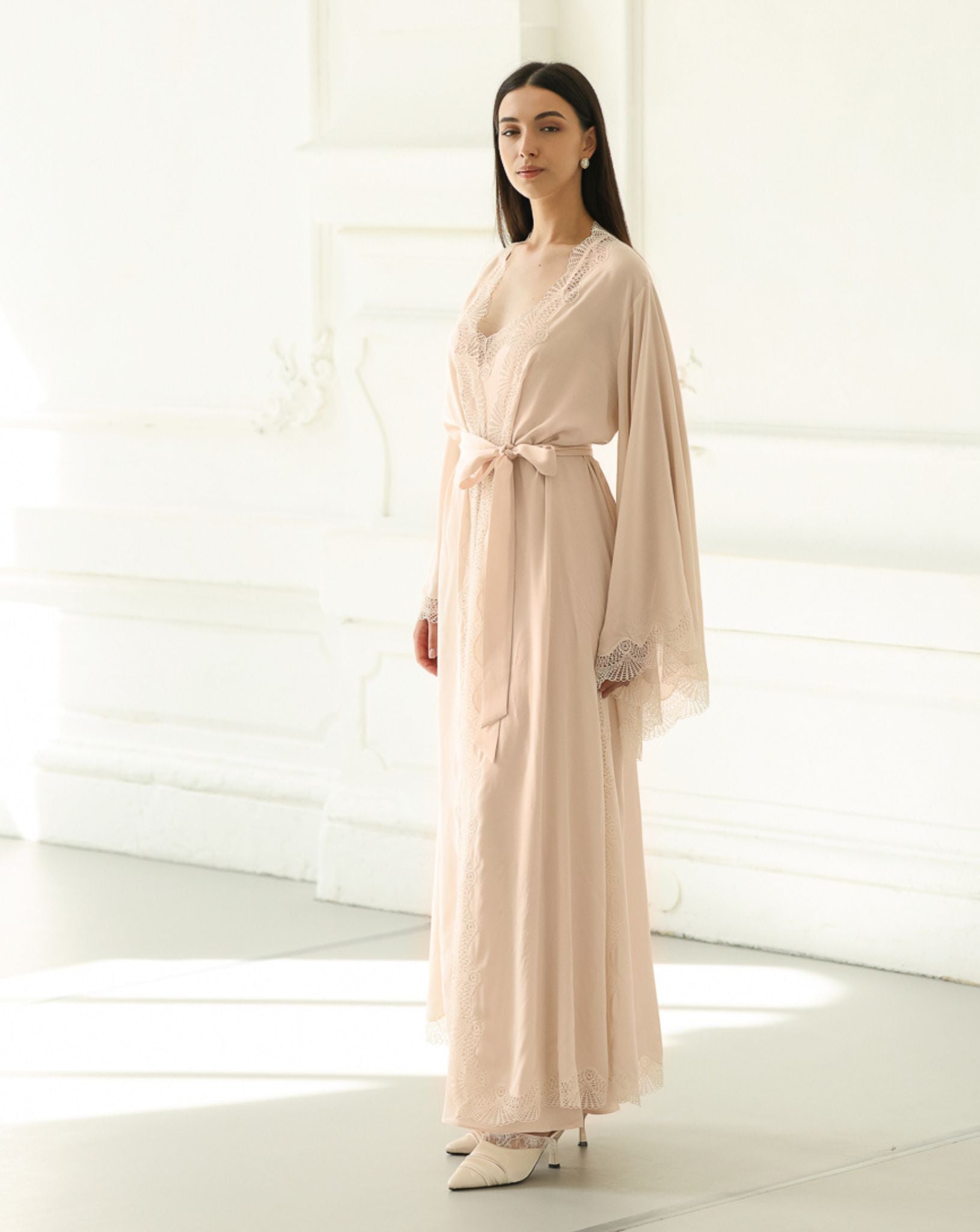 Frontal view of the belted wrap-over robe, illustrating a graceful silhouette that moves effortlessly with the body.