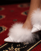 Close-up of feet crossed, illustrating how the voluminous feathers sway beautifully with every movement.