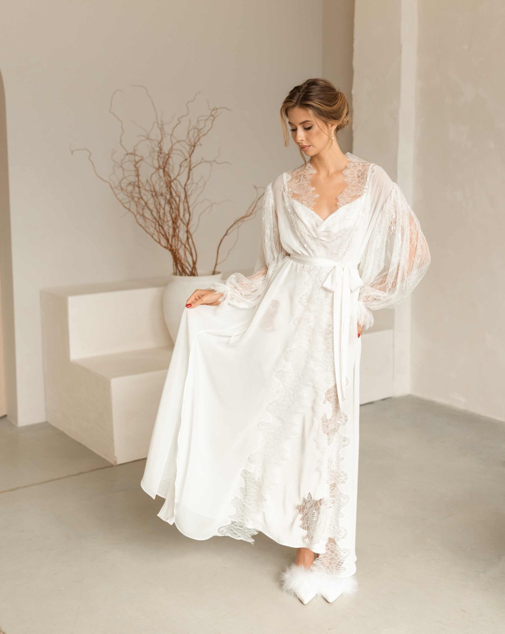 Model in the Peony set gracefully lifting the edge of the airy chiffon robe to show the delicate lace trim.
