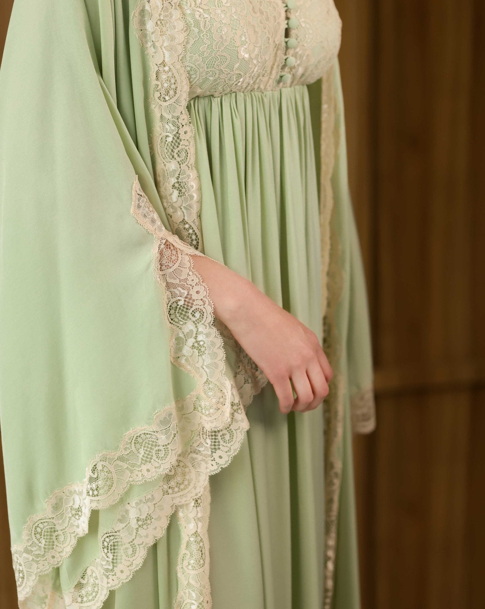 Close-up of the wide sleeve finish, showcasing the intricate floral lace embroidery that adds a beautiful touch.