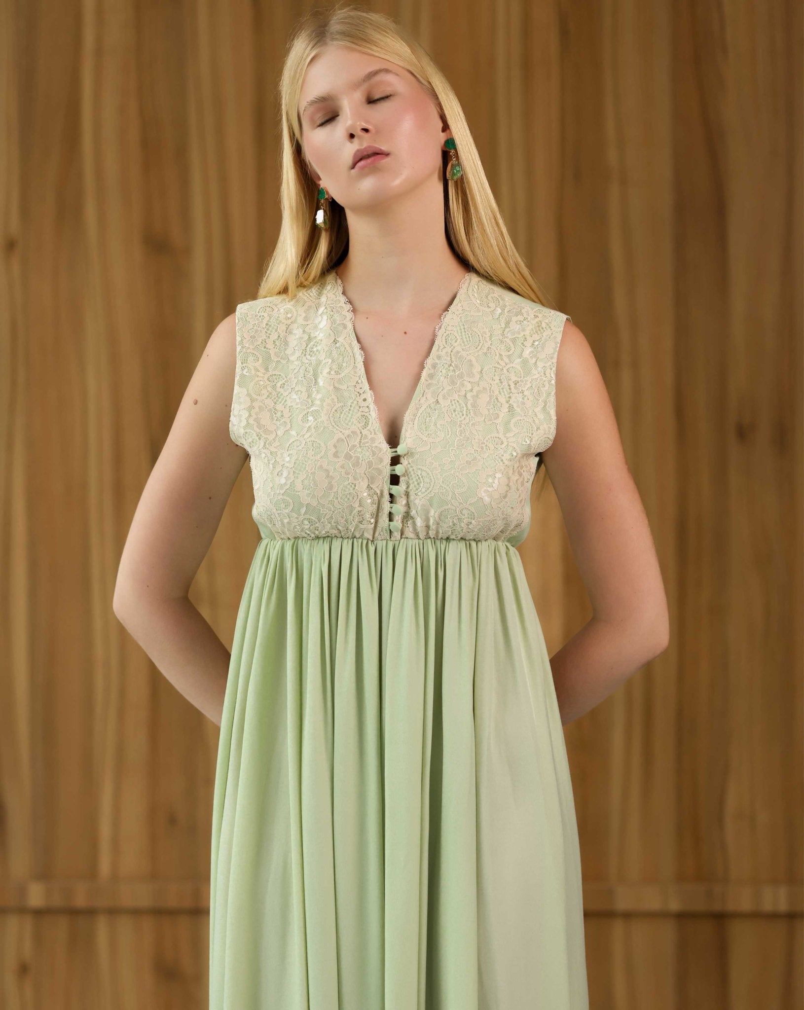 Mid-length view focusing on the delicate floral lace at the neckline and the practical buttoned access for nursing.