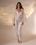 A full-length shot of a woman with her hair and robe flowing beautifully, creating a sense of graceful movement.