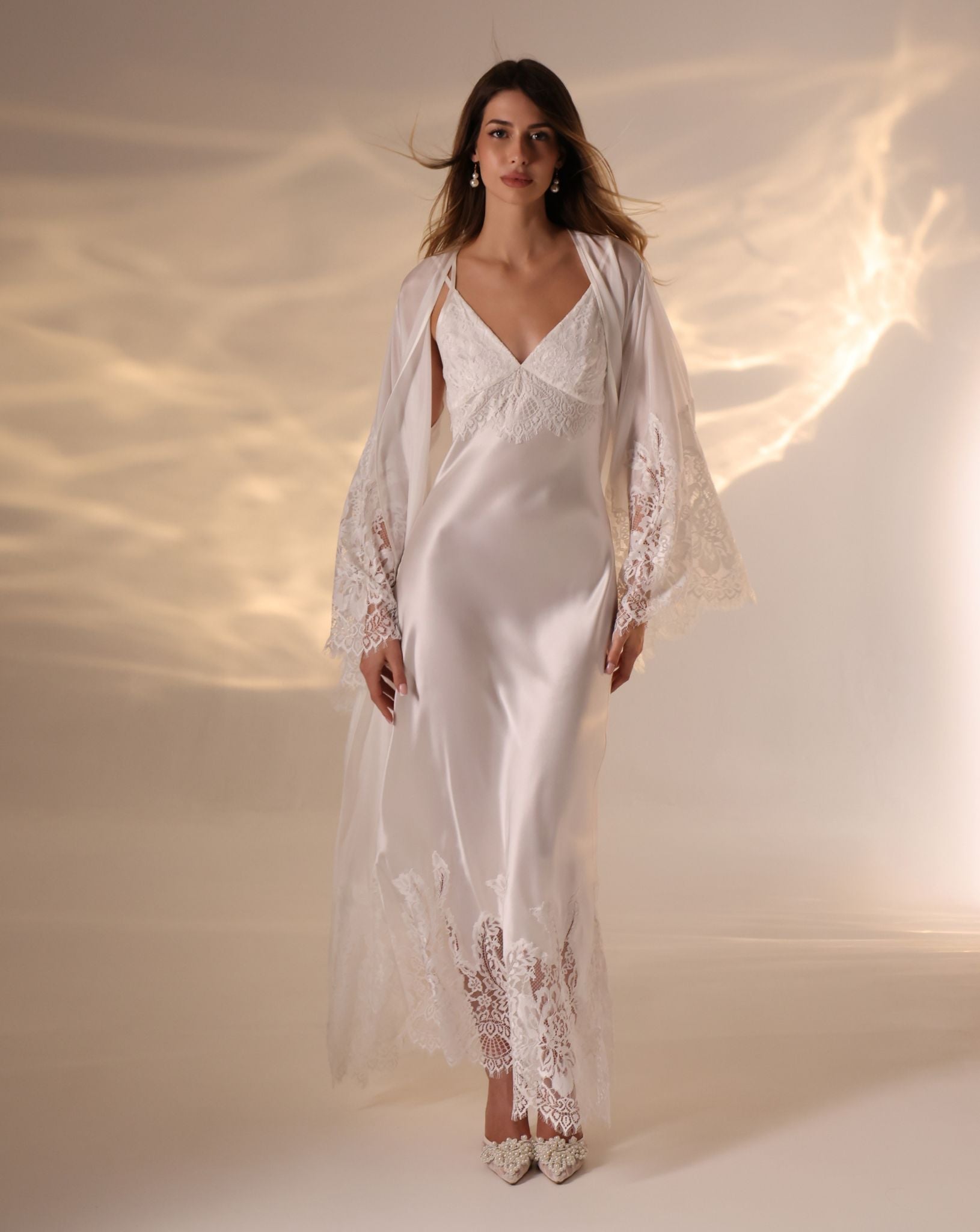 A full-length shot of a woman with her hair and robe flowing beautifully, creating a sense of graceful movement.