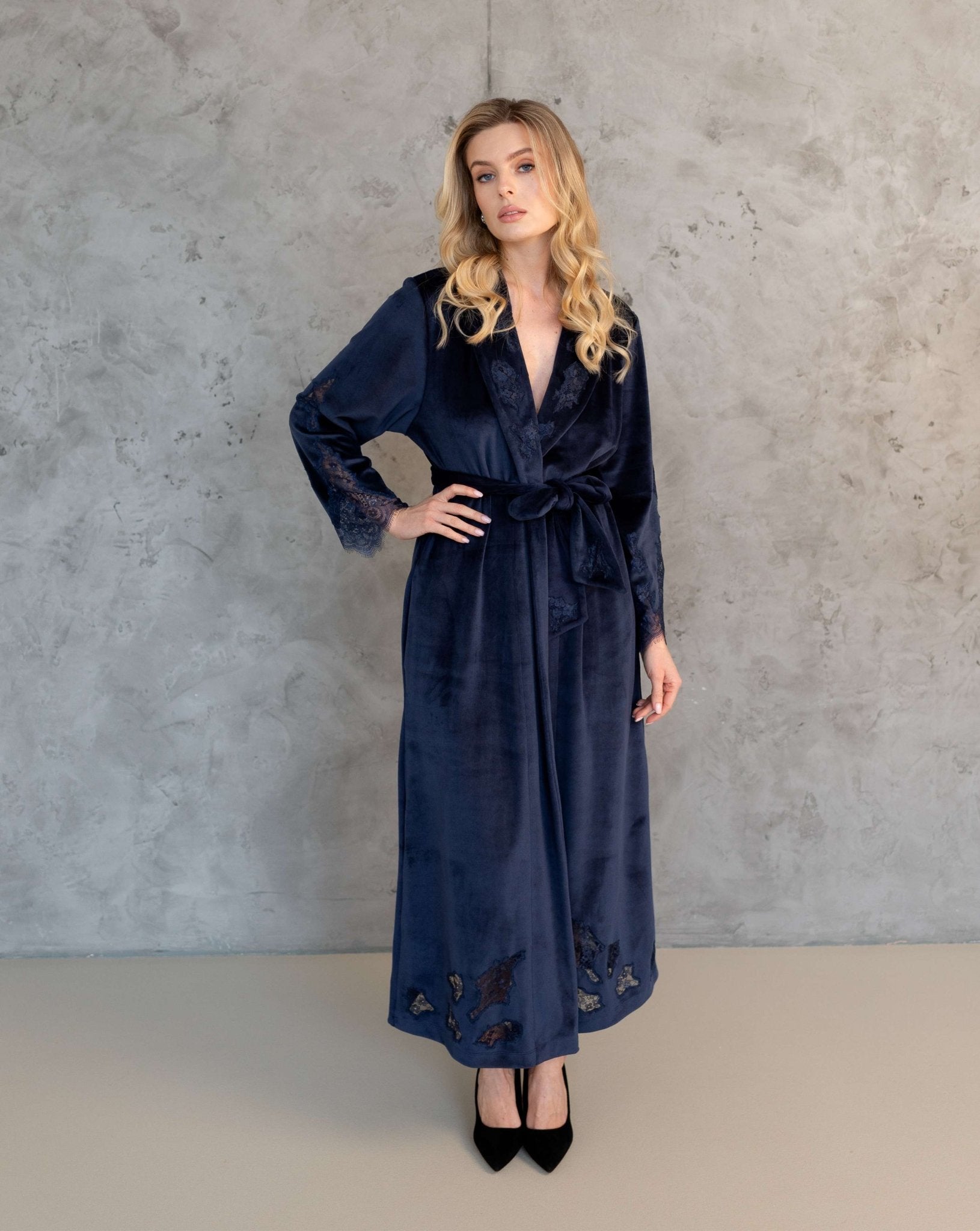Full-length shot of the elegant velvet robe with a hand on the waist, highlighting the luxurious fabric and lace finish.