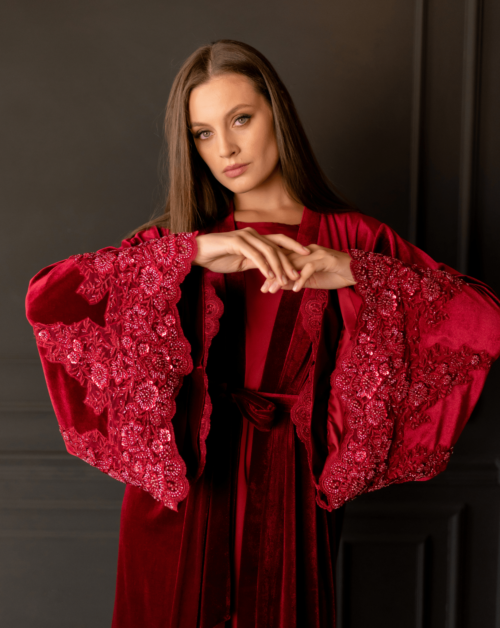 Mid-length shot focusing on the intricately decorated sleeves and the rich, soft-to-the-touch velvet material.