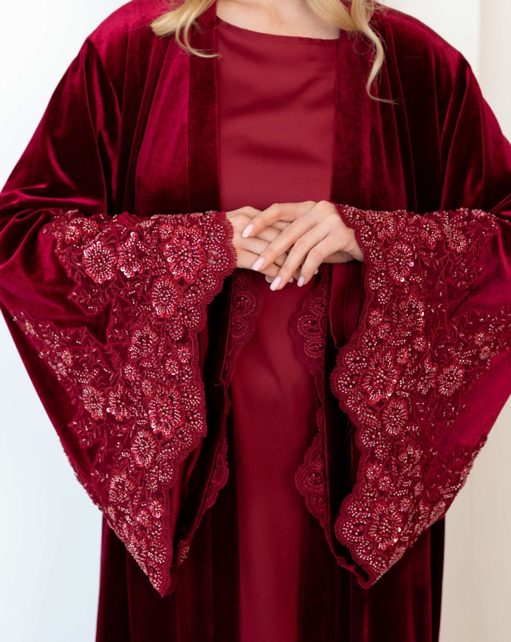 Close-up of the sleeve detail, featuring hand-applied beads and sequins that add a sophisticated touch to the look.