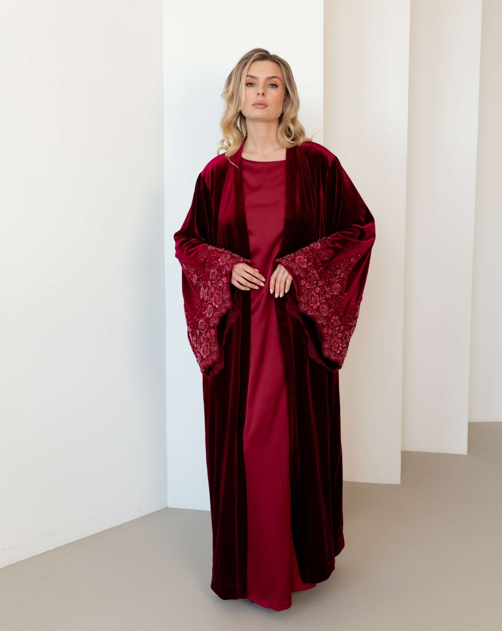 Full-length view of the velvet Abaya and satin dress, showcasing the elegant contrast of two different textures.