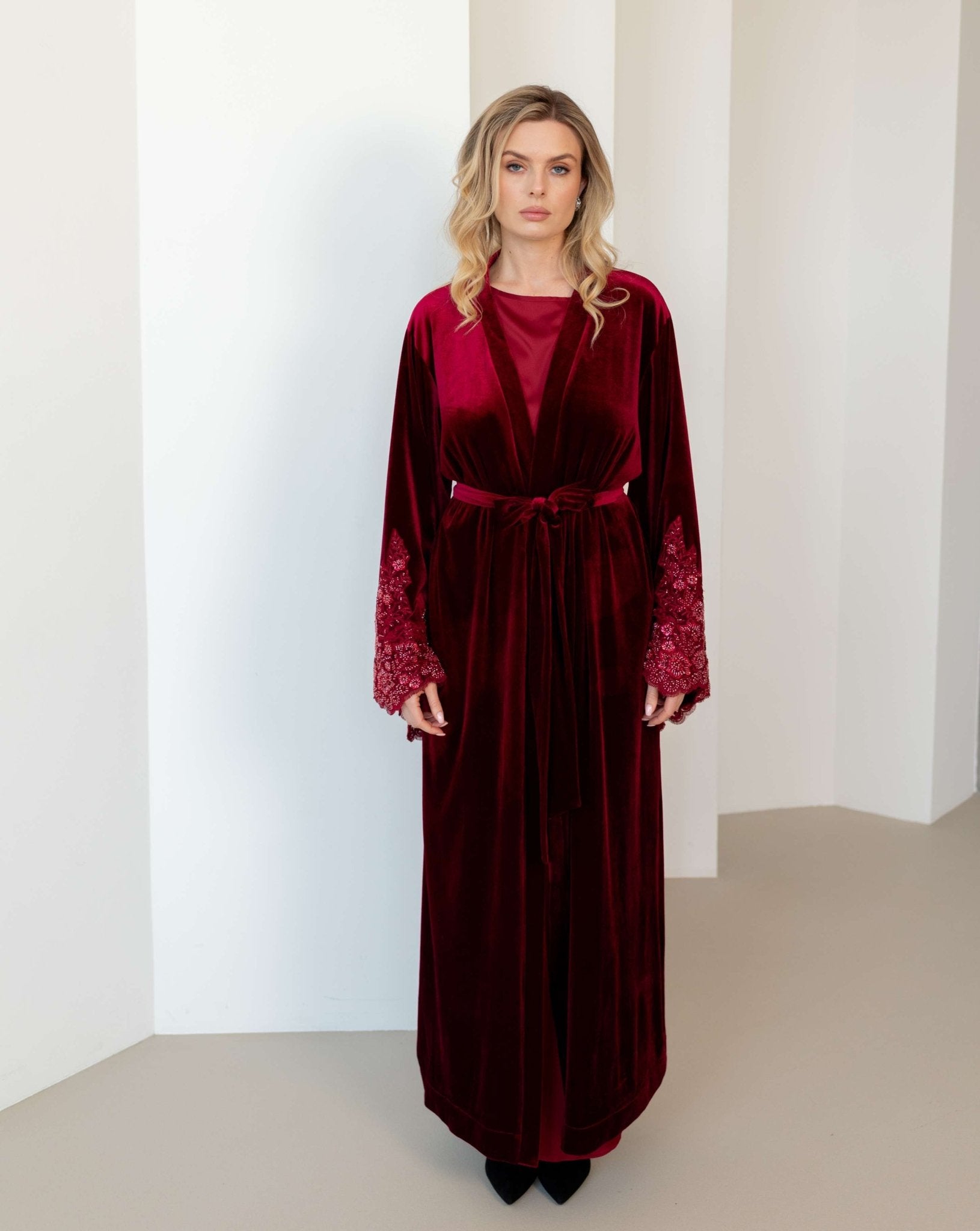 The wrap-over style ensemble tied with a belt, illustrating a perfect pair of soft velvet and smooth satin.