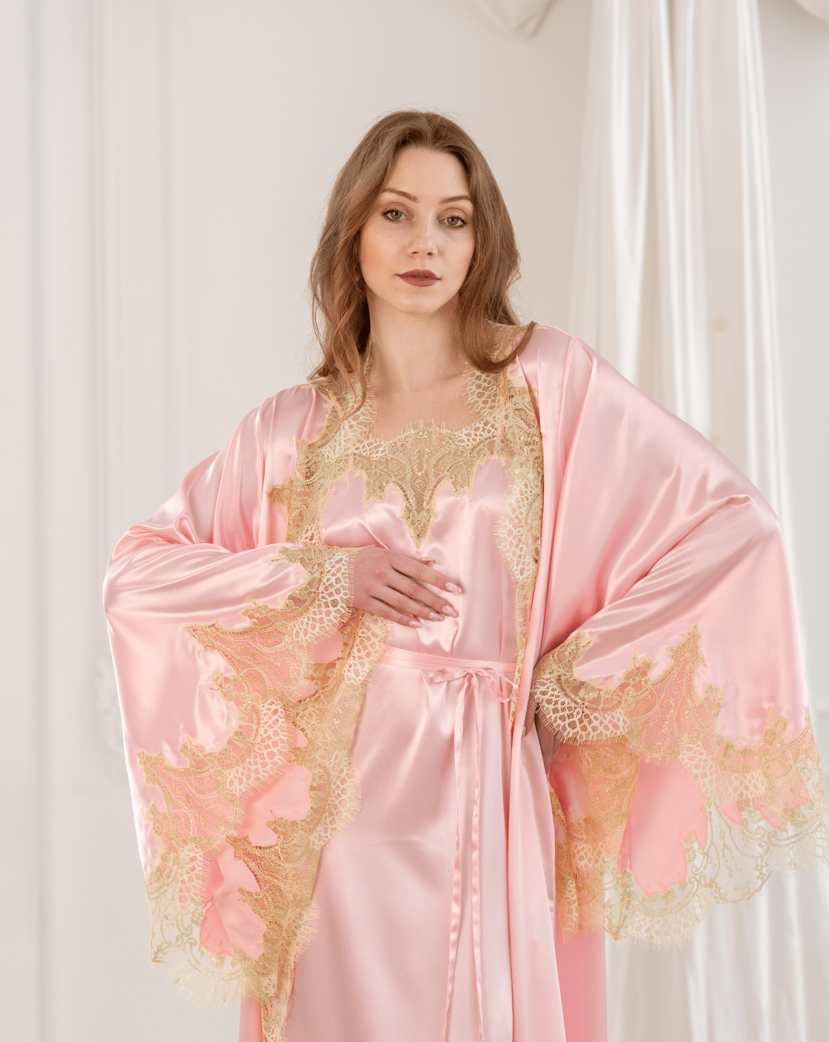 Mid-length frontal view showcasing the sweeping sleeves and wide lace cuffs of the elegant matching robe.
