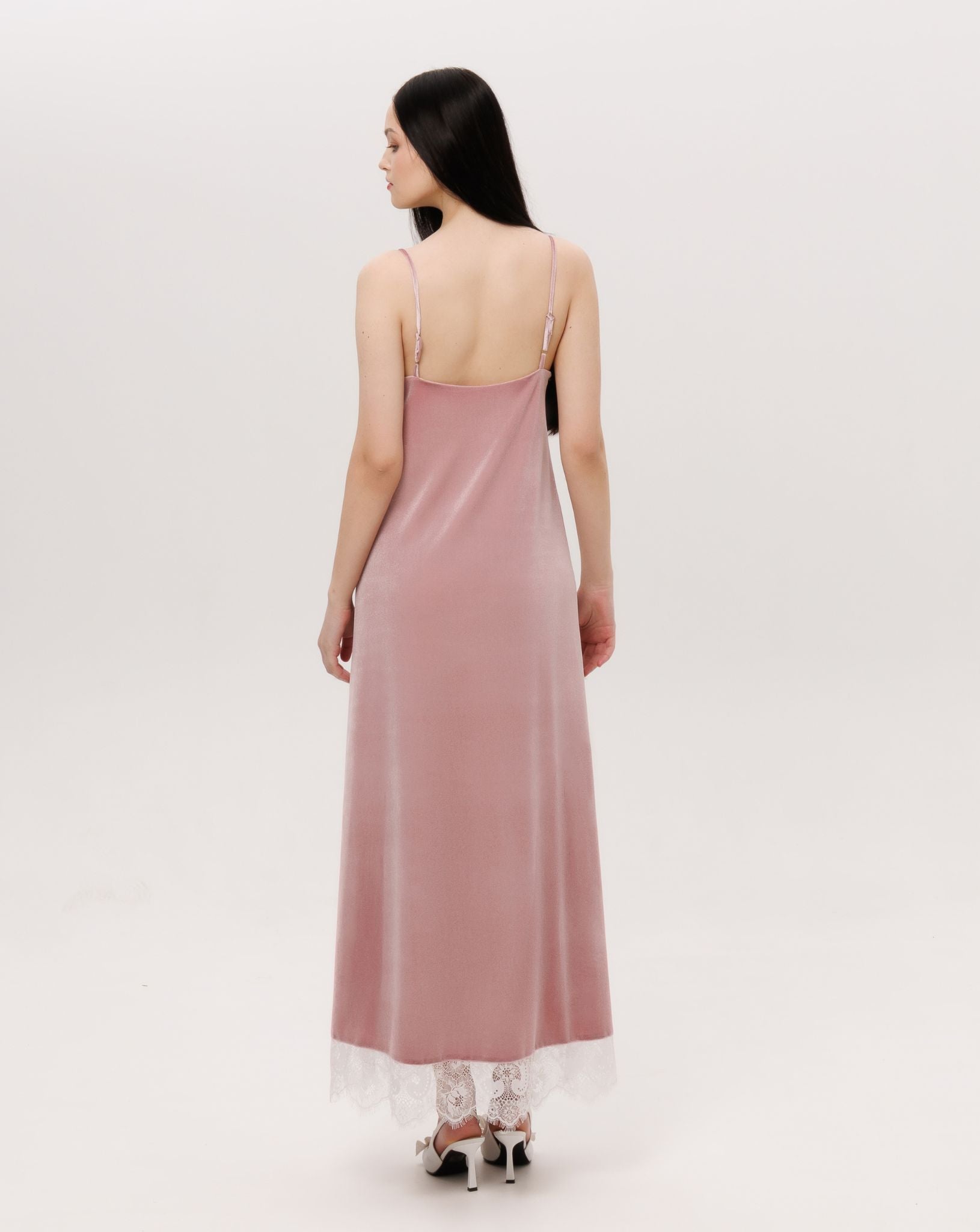 Back perspective of the long velvet gown, showing how the material follows the figure with ease and warmth.