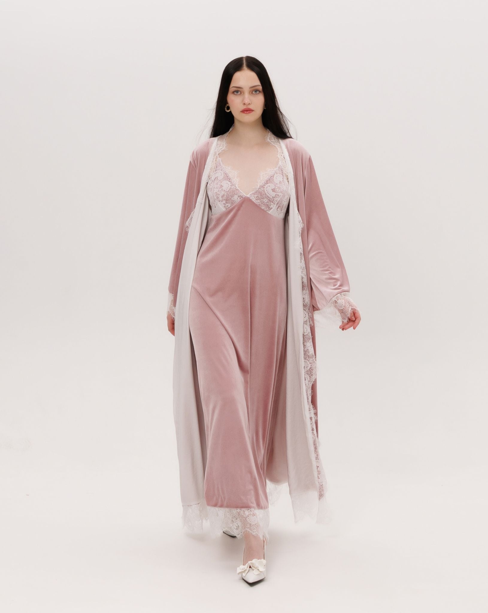 Capturing the graceful weight of the velvet ensemble as it moves, highlighting the effortless grandeur in every fold.