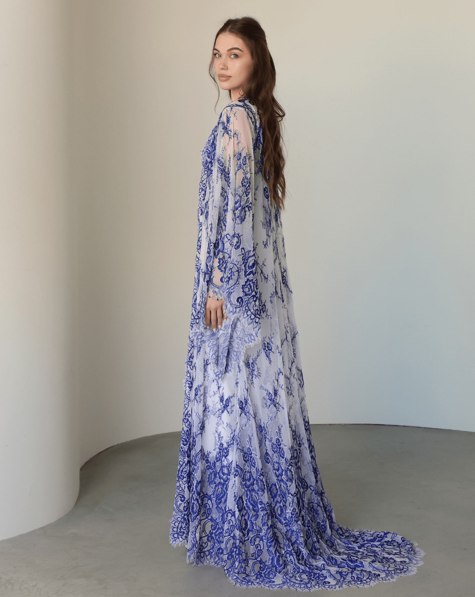 Back view of the complete ensemble, highlighting how the long lace train creates a dramatic, flowing look.
